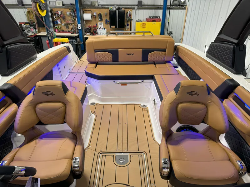 Slide: The Image of 2025 Chaparral 267 SSX boat interior with tan leather seats and modern design. - 22