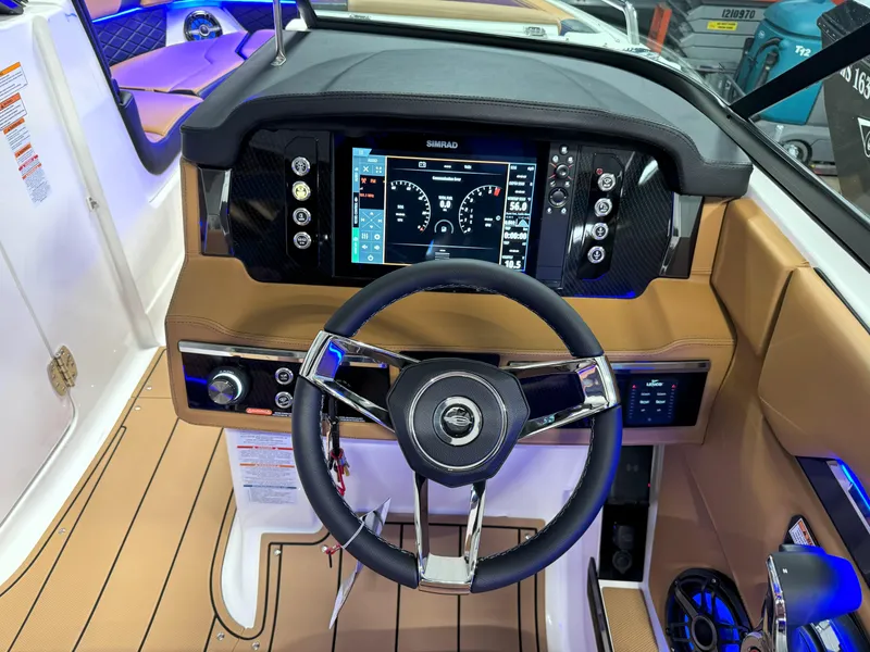 Slide: The Image of 2025 Chaparral 267 SSX dashboard with modern steering and digital display. - 24