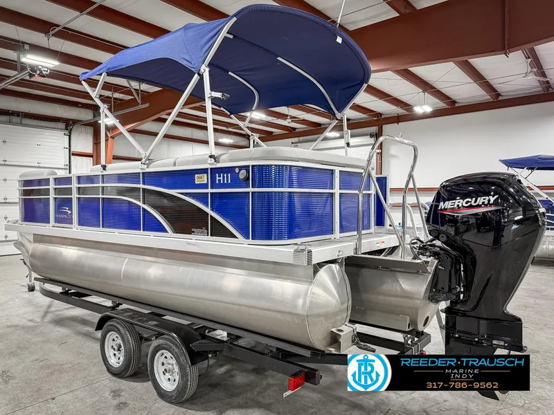 Slide: The Image of 2023 Bennington 208 SL pontoon boat with Mercury engine in indoor showroom. - 10