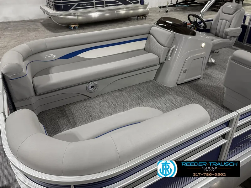 Slide: The Image of 2023 Bennington 208 SL pontoon boat interior with gray seating and steering console. - 12