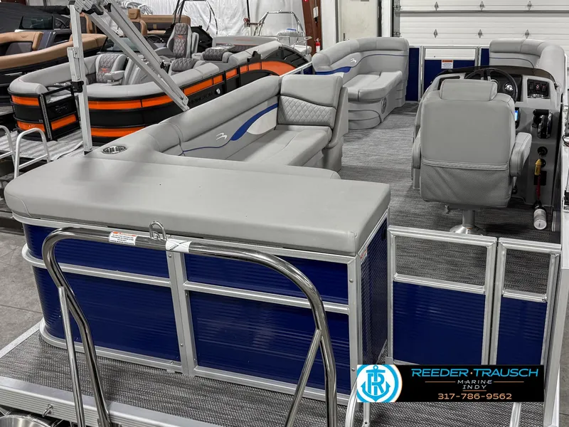 Slide: The Image of 2023 Bennington 208 SL pontoon boat interior with gray seating and blue paneling. - 14