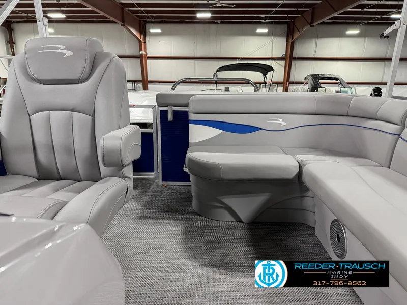 Slide: The Image of 2023 Bennington 208 SL boat interior with gray seating and blue accents. - 17