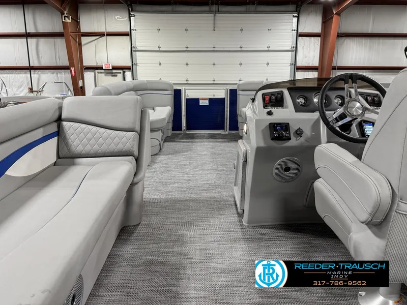 Slide: The Image of 2023 Bennington 208 SL pontoon boat interior with gray seating and modern dashboard. - 18