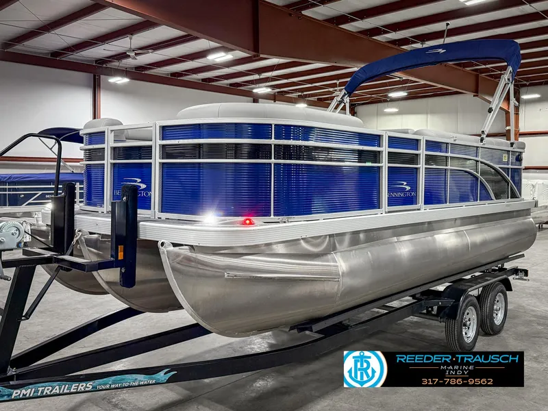 Slide: The Image of 2023 Bennington 208 SL pontoon boat on trailer in indoor showroom. - 2