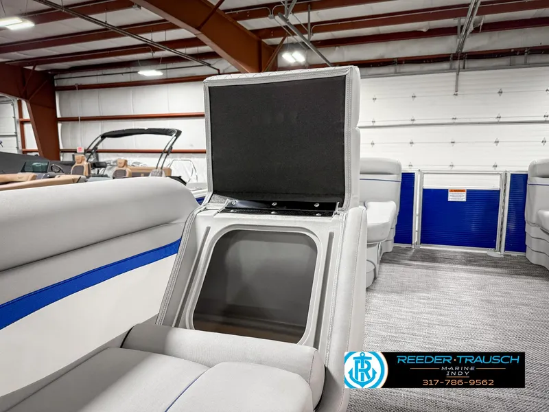 Slide: The Image of 2023 Bennington 208 SL boat interior with storage compartment open in showroom. - 22
