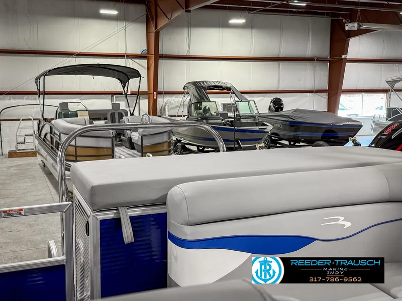 Slide: The Image of 2023 Bennington 208 SL pontoon boat displayed in a showroom. - 28