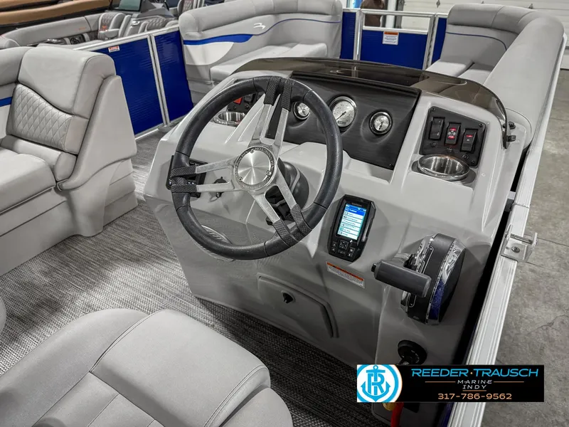Slide: The Image of 2023 Bennington 208 SL boat interior with steering wheel and dashboard controls. - 29
