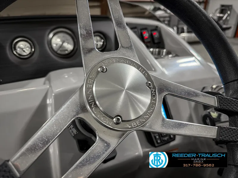 Slide: The Image of Steering wheel of a 2023 Bennington 208 SL boat, featuring dashboard controls. - 31