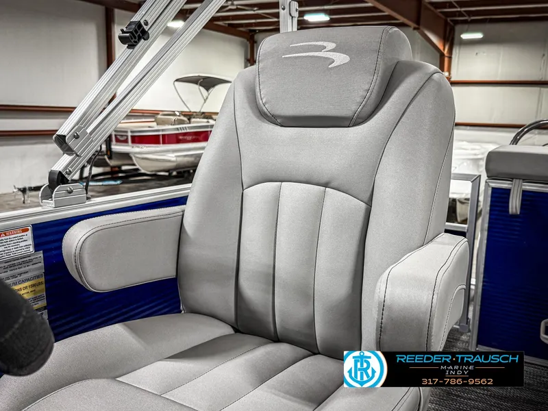 Slide: The Image of 2023 Bennington 208 SL boat seat in showroom, featuring plush gray upholstery. - 38