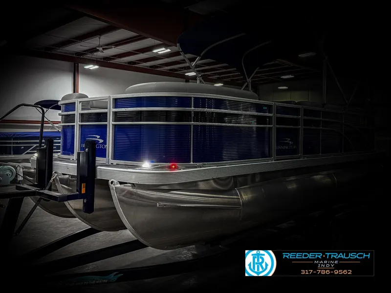 Slide: The Image of 2023 Bennington 208 SL pontoon boat in showroom, featuring sleek design and modern amenities. - 4