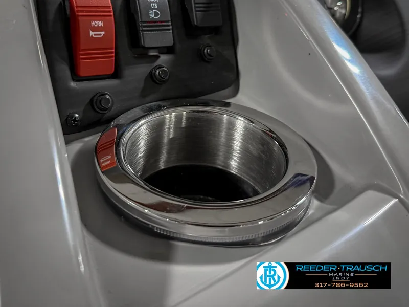 Slide: The Image of 2023 Bennington 208 SL boat console with cup holder and control switches. - 42