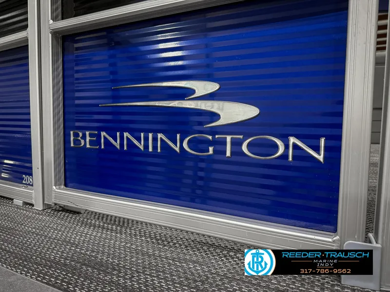 Slide: The Image of 2023 Bennington 208 SL boat logo on blue panel, Reeder-Trausch Marine branding. - 48