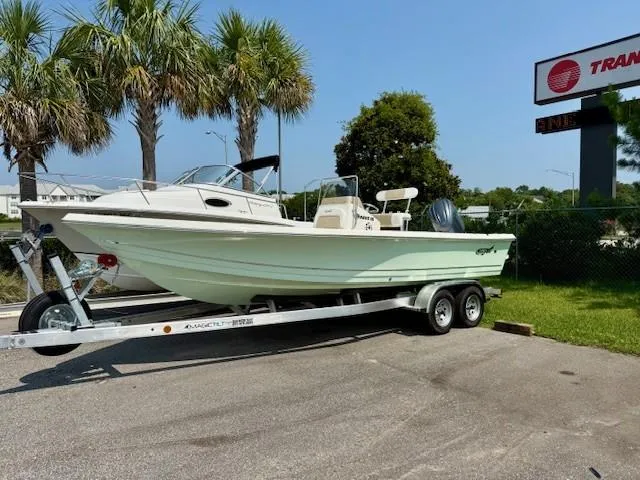 Slide: The Image of 2025 Bulls Bay 2200 boat on trailer, parked outdoors near palm trees. - 2