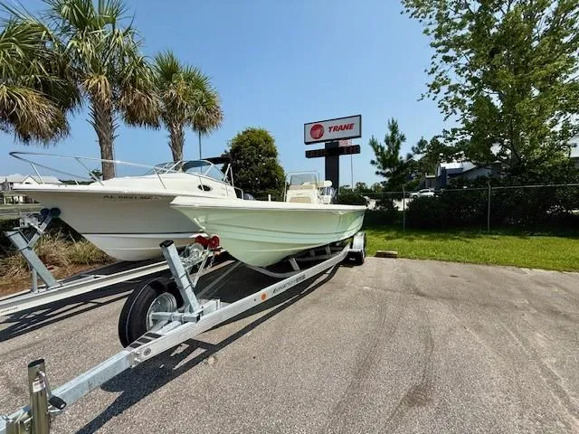 Slide: The Image of 2025 Bulls Bay 2200 boat on trailer, parked outdoors near palm trees. - 3