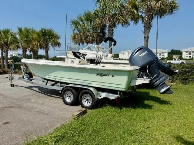 The Image of 2025 Bulls Bay 2200 boat on trailer, parked near palm trees, featuring Yamaha outboard motor. - 0