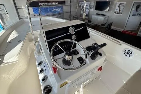 Slide: The Image of 2025 Bulls Bay 2200 boat console with steering wheel and controls in showroom. - 5