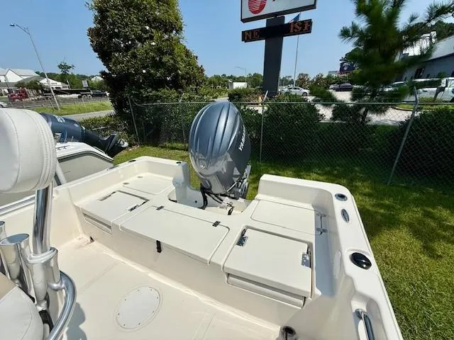 Slide: The Image of 2025 Bulls Bay 2200 boat with outboard motor, parked outdoors on grass. - 6