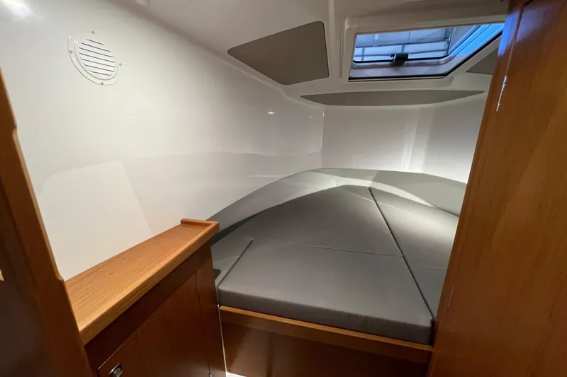 Slide: The Image of 2025 Sargo All Season boat cabin with cozy bed and wooden accents. - 12