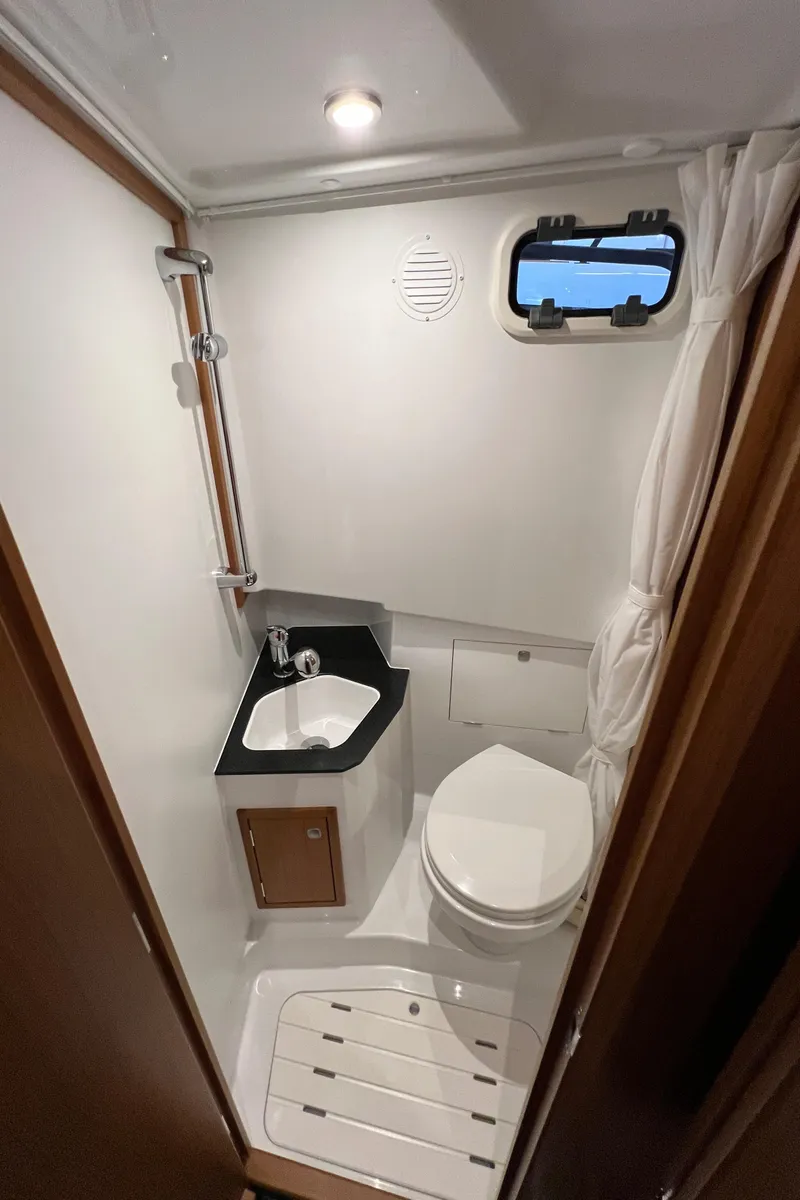 Slide: The Image of 2025 Sargo All Season boat bathroom with compact design, featuring sink, toilet, and window. - 14