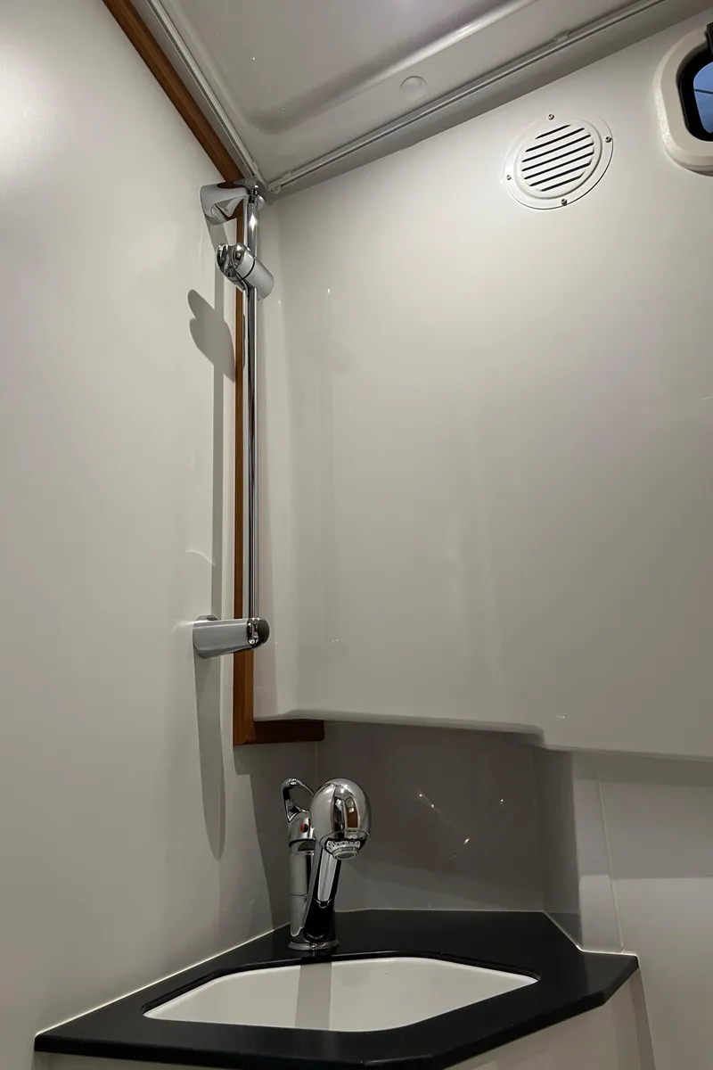 Slide: The Image of 2025 Sargo All Season boat bathroom with modern shower and sink. - 16