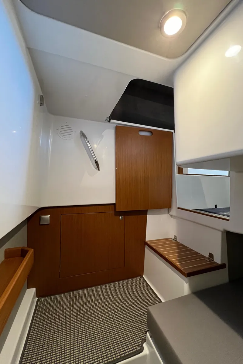 Slide: The Image of Interior of 2025 Sargo All Season boat, featuring modern wood and white design. - 20