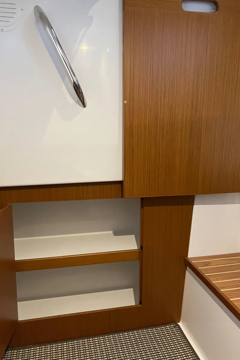 Slide: The Image of Interior of 2025 Sargo All Season boat with wooden cabinetry and shelving. - 21