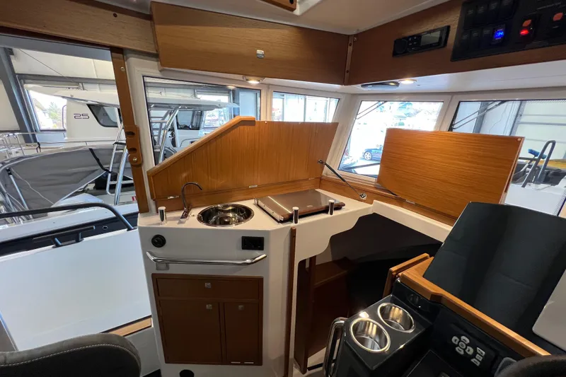 Slide: The Image of Interior of 2025 Sargo All Season boat with compact kitchen and modern controls. - 9