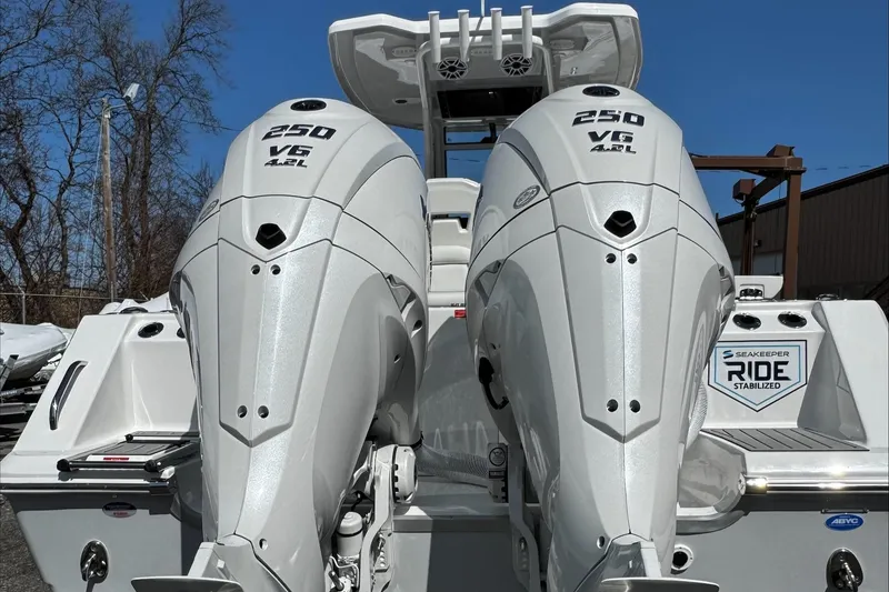 Slide: The Image of 2025 Tidewater 282 CC Adventure with twin 250 V6 outboard engines, rear view. - 10