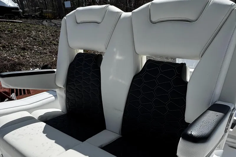 Slide: The Image of 2025 Tidewater 282 CC Adventure boat seats with white and black upholstery. - 11