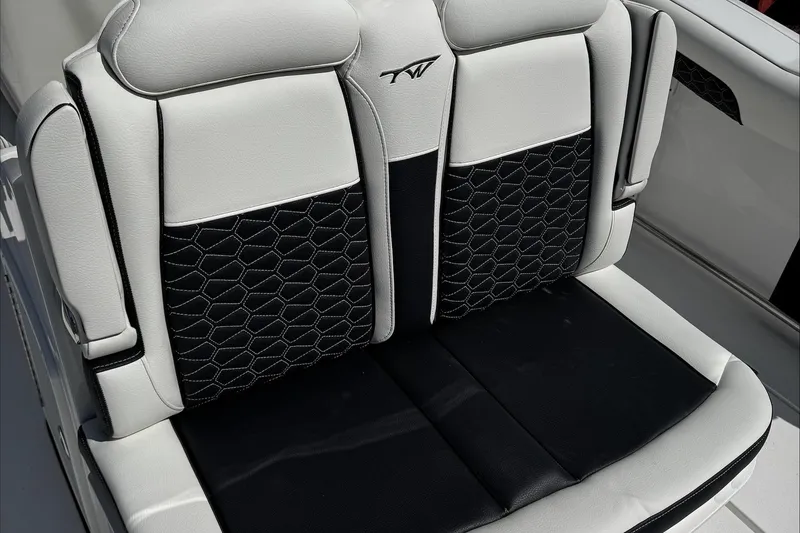 Slide: The Image of 2025 Tidewater 282 CC Adventure boat seat with black and white upholstery. - 12
