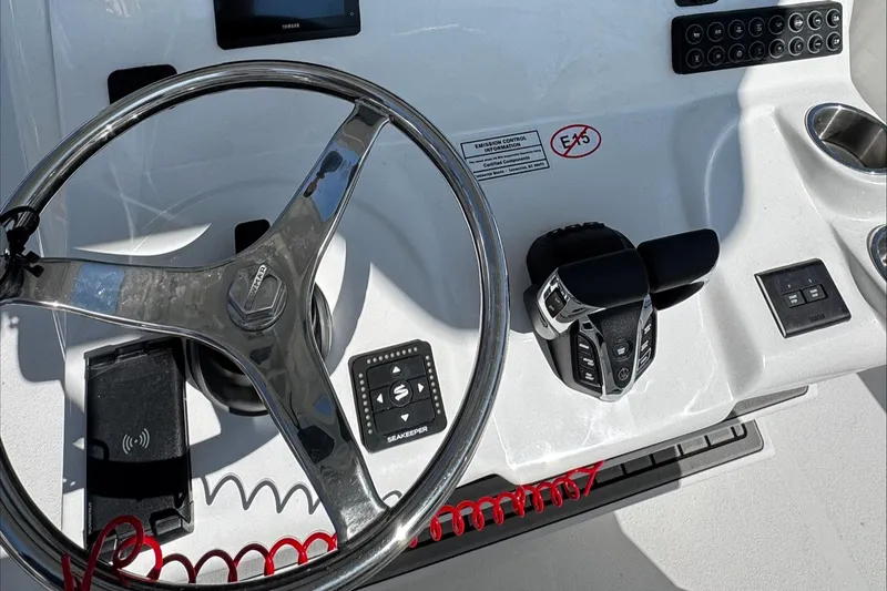 Slide: The Image of Steering console of 2025 Tidewater 282 CC Adventure boat with modern controls. - 16