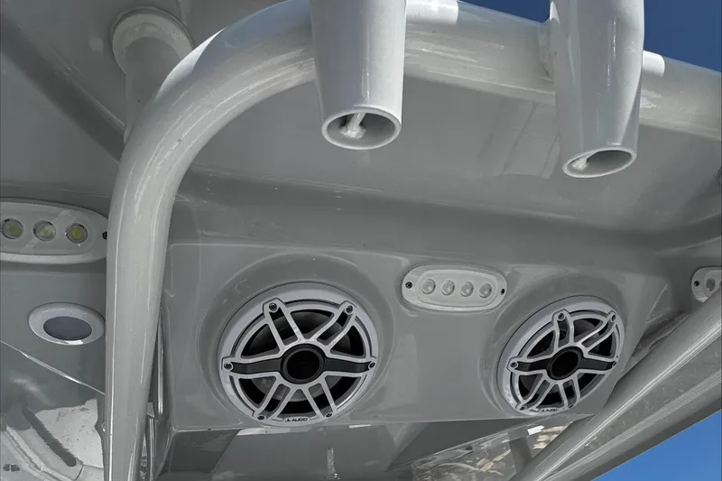 Slide: The Image of 2025 Tidewater 282 CC Adventure boat speakers and rod holders under T-top. - 18