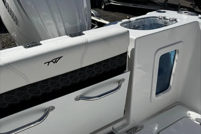 Slide: The Image of 2025 Tidewater 282 CC Adventure boat interior with storage and sleek design. - 22