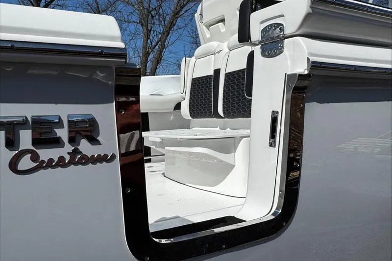 Slide: The Image of 2025 Tidewater 282 CC Adventure boat with open side door and seating area. - 24