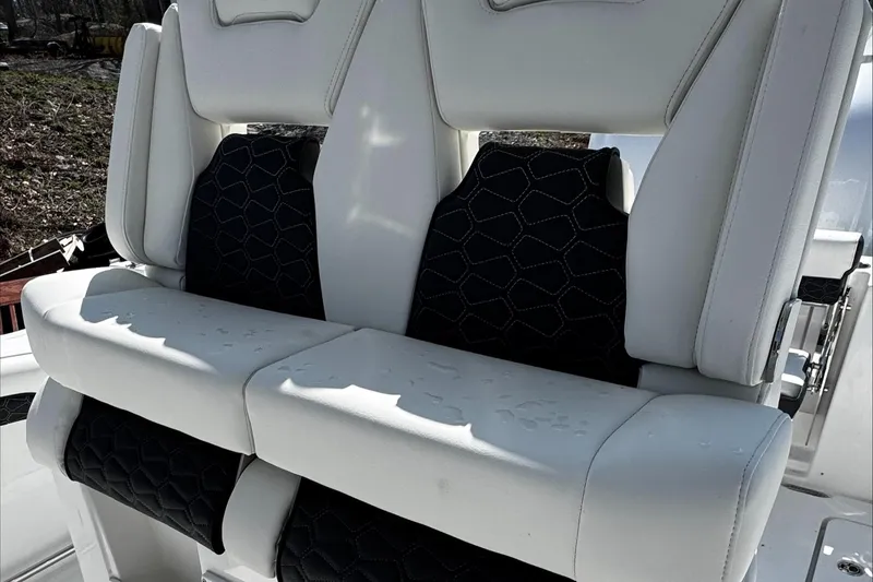 Slide: The Image of 2025 Tidewater 282 CC Adventure boat seats, featuring white and black upholstery with geometric patterns. - 25