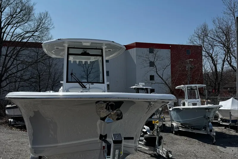 Slide: The Image of 2025 Tidewater 282 CC Adventure boat parked outdoors near industrial building. - 28
