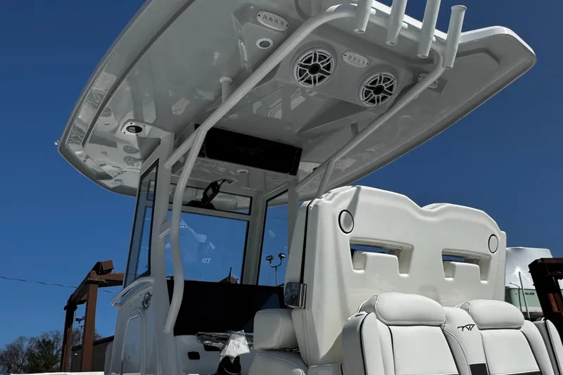 Slide: The Image of 2025 Tidewater 282 CC Adventure boat with sleek design and modern features under a clear blue sky. - 7