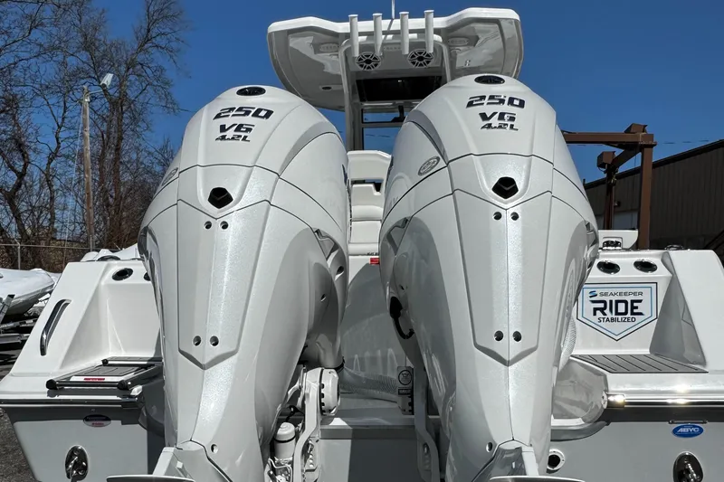 Slide: The Image of 2025 Tidewater 282 CC Adventure boat with dual 250 V6 engines, rear view. - 9