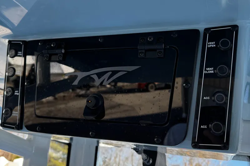 Slide: The Image of Control panel of 2025 Tidewater 232 LXF boat with switches and logo. - 14