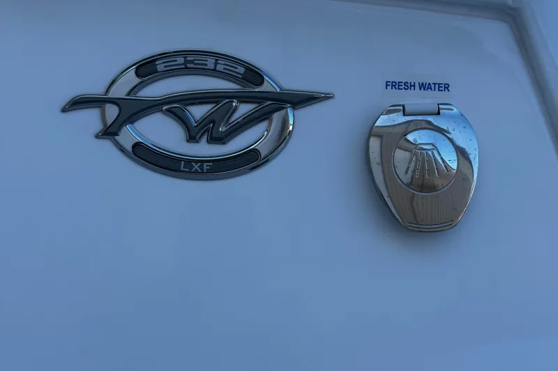 Slide: The Image of Tidewater 232 LXF 2025 emblem and fresh water access on boat exterior. - 15