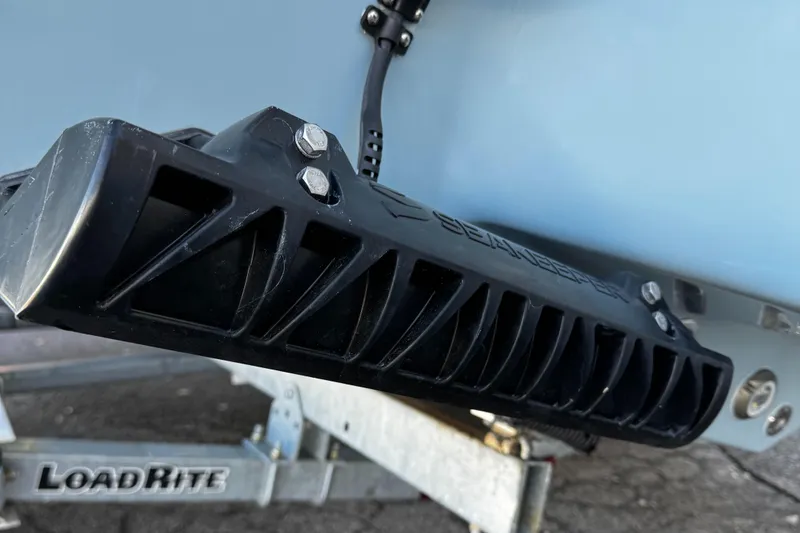 Slide: The Image of 2025 Tidewater 232 LXF boat on Load Rite trailer, close-up of hull and support. - 17