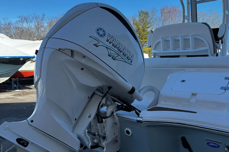 Slide: The Image of 2025 Tidewater 232 LXF boat with Yamaha outboard motor, docked outdoors. - 6