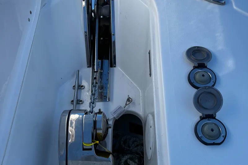 Slide: The Image of 2025 Tidewater 232 LXF boat anchor compartment with chain and cleats. - 7