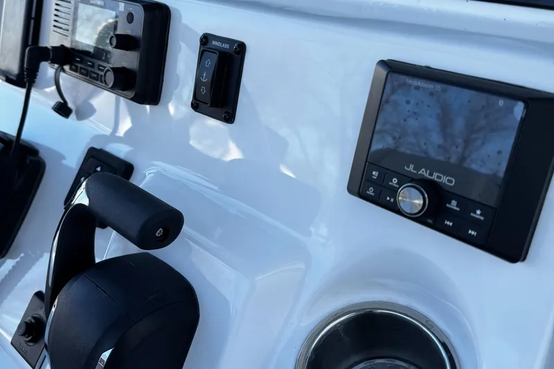 Slide: The Image of Control panel of 2025 Tidewater 232 LXF boat with audio system and throttle. - 8