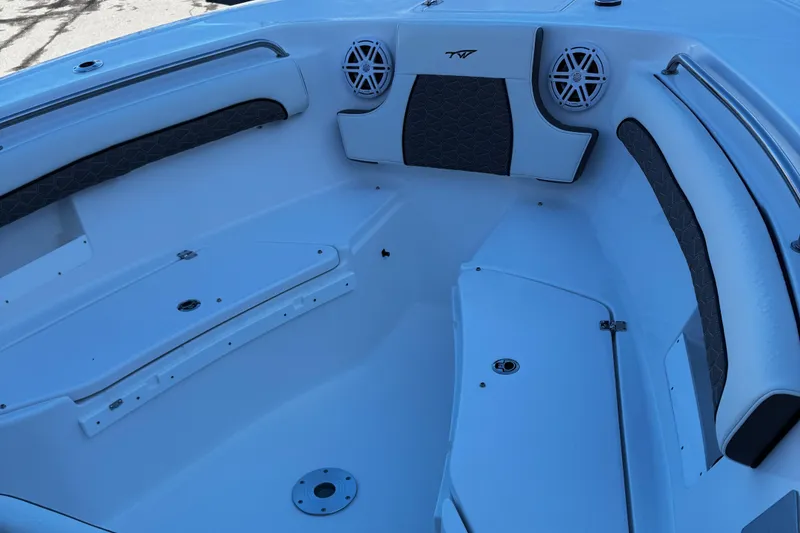 Slide: The Image of 2025 Tidewater 232 LXF boat interior with seating and speakers. - 9