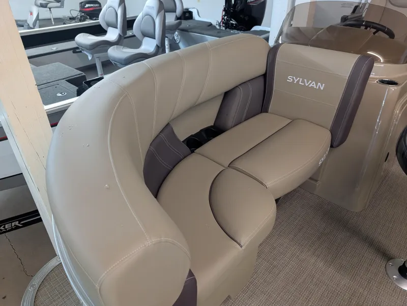 Slide: The Image of Luxurious seating in 2025 Sylvan Mirage Cruise 8520 CLZ DH pontoon boat, featuring beige upholstery. - 2