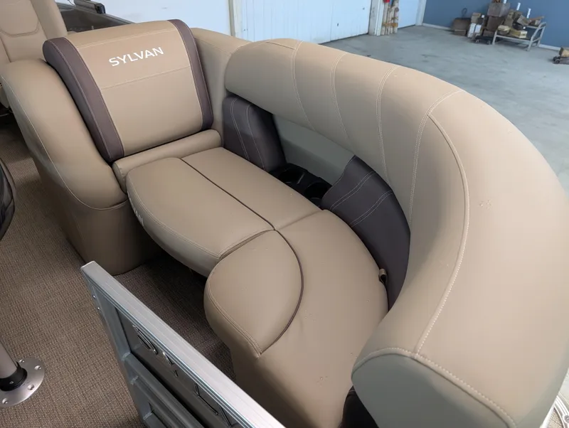 Slide: The Image of 2025 Sylvan Mirage Cruise 8520 CLZ DH boat interior with beige and brown seating. - 3
