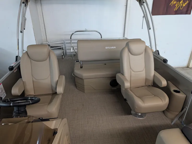 Slide: The Image of 2025 Sylvan Mirage Cruise 8520 CLZ DH interior with beige seating and carpet. - 4