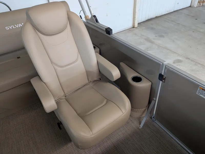 Slide: The Image of Beige captain's chair in 2025 Sylvan Mirage Cruise 8520 CLZ DH pontoon boat interior. - 5