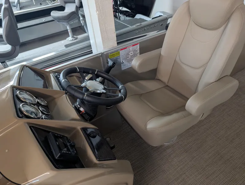 Slide: The Image of 2025 Sylvan Mirage Cruise 8520 CLZ DH boat interior with steering wheel and captain's chair. - 6
